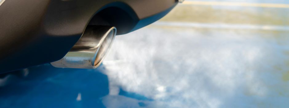 close up of vehicle exhaust pipe with emissions